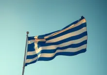 Vibrant Greek Flag Fluttering in Clear Sky: High-Quality HDR Photography