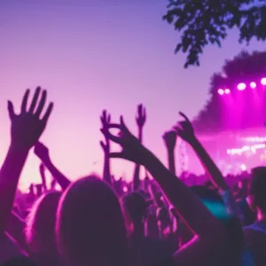 A vibrant outdoor music festival scene during sunset, with colorful stage lighting