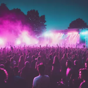 A vibrant outdoor music festival scene during sunset, with colorful stage lighting