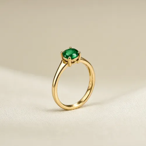 Create a premium jewelry photograph featuring one gold ring with a small