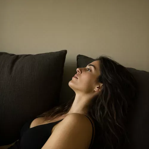 An intimate side-profile portrait of a woman in their late twenties