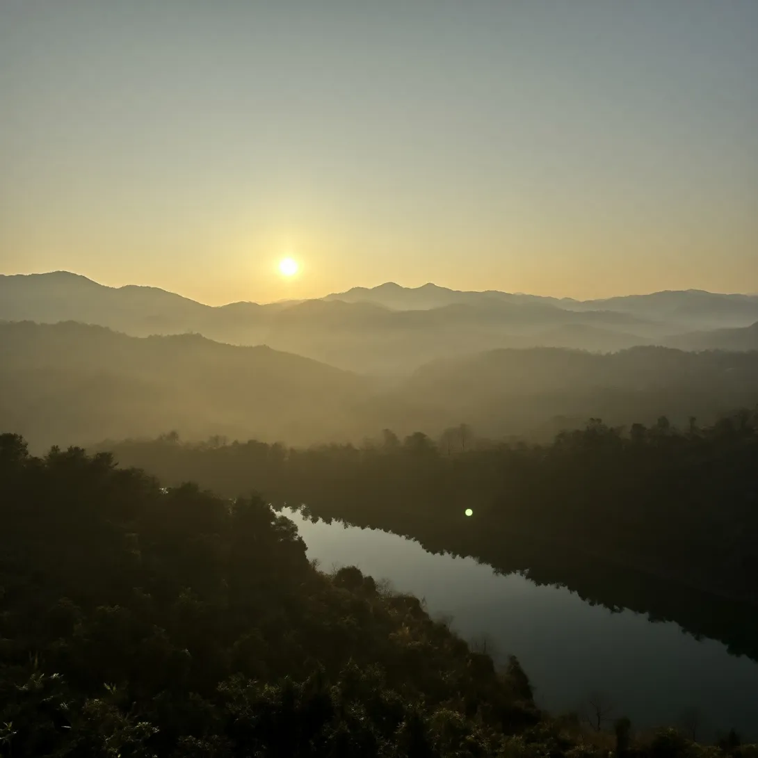 A dawn landscape of layered mountain ridges